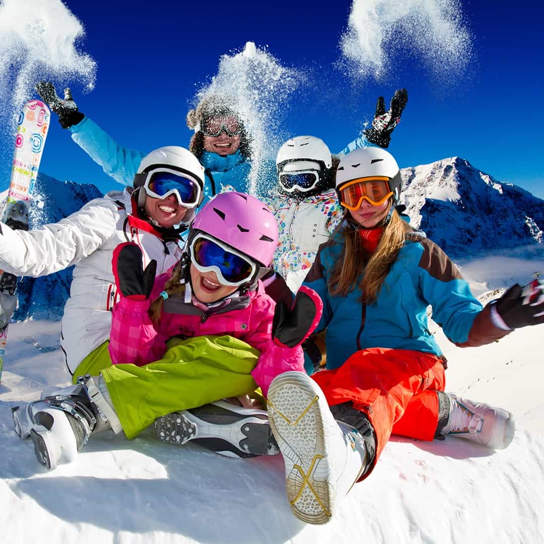 Friends celebrating together on a snowy ski trip